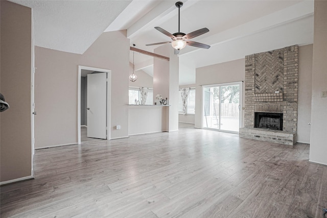 1103 W Brompton Dr, Pearland, TX 77584 - unfurnished living room featuring beamed ceiling, ceiling fan, wood finished floors, a brick fireplace, and high vaulted ceiling