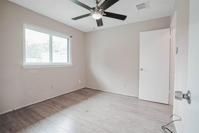 1103 W Brompton Dr, Pearland, TX 77584 - unfurnished room with light wood-style flooring, a ceiling fan, and a textured ceiling