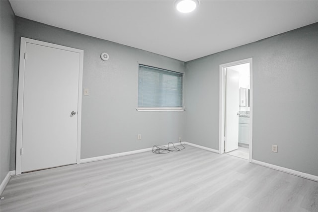 1103 W Brompton Dr, Pearland, TX 77584 - unfurnished bedroom with wood finished floors and connected bathroom