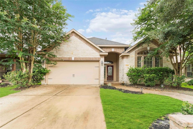 18843 Cove Pointe Dr, Cypress, TX 77433 - view of front facade with stone siding, concrete driveway, a front yard, and a garage