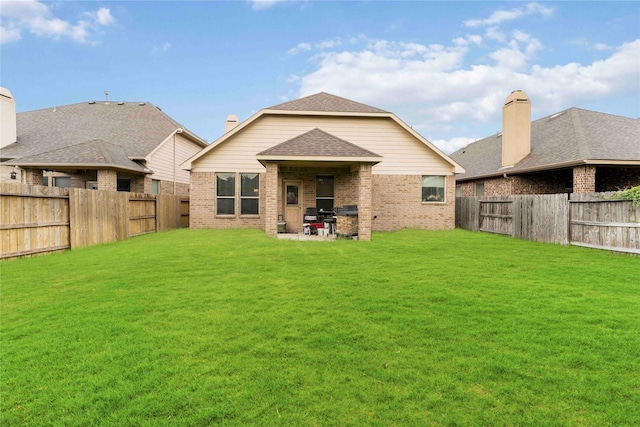 18843 Cove Pointe Dr, Cypress, TX 77433 - back of house featuring brick siding, a fenced backyard, a patio, and a shingled roof