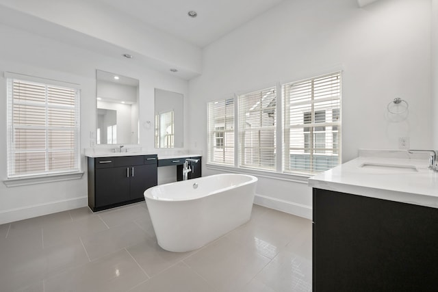 614 Delmar St, Houston, TX 77023 - bathroom with vanity, a freestanding bath, healthy amount of natural light, and tile patterned floors