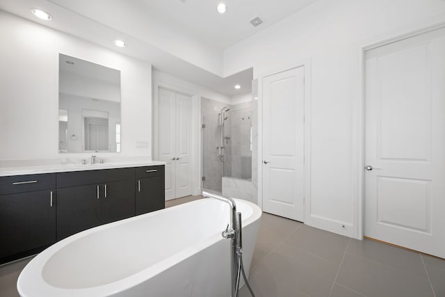 614 Delmar St, Houston, TX 77023 - bathroom with a stall shower, a soaking tub, vanity, tile patterned flooring, and recessed lighting
