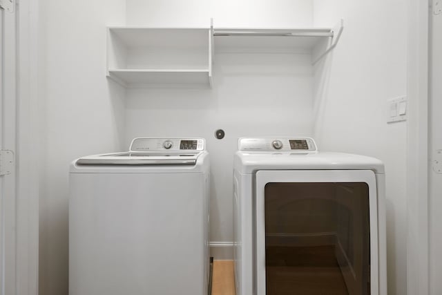 614 Delmar St, Houston, TX 77023 - washroom with washer and clothes dryer and wood finished floors