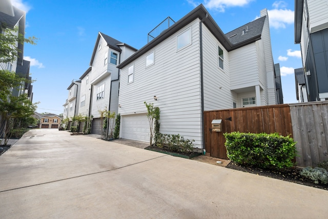 614 Delmar St, Houston, TX 77023 - view of side of home featuring driveway, a garage, and a residential view