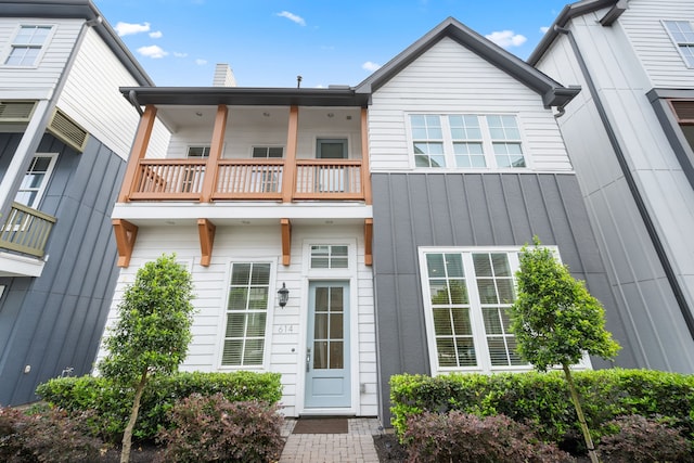 614 Delmar St, Houston, TX 77023 - rear view of property featuring a balcony, a chimney, and board and batten siding