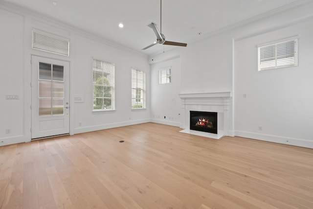 614 Delmar St, Houston, TX 77023 - unfurnished living room with ornamental molding, a ceiling fan, light wood-type flooring, a fireplace with flush hearth, and recessed lighting