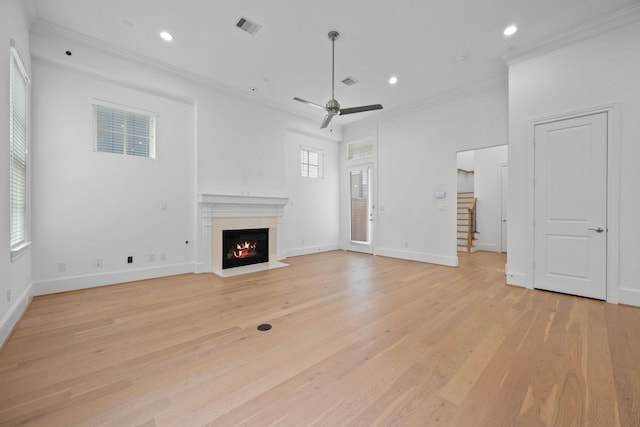 614 Delmar St, Houston, TX 77023 - unfurnished living room featuring ornamental molding, a fireplace with flush hearth, light wood finished floors, ceiling fan, and recessed lighting