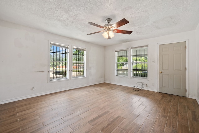 3822 Wipprecht St, Houston, TX 77026 - empty room featuring a textured ceiling, a ceiling fan, and wood finished floors