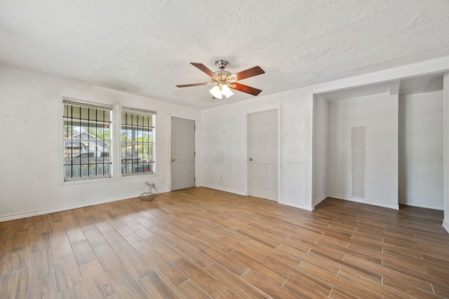 3822 Wipprecht St, Houston, TX 77026 - spare room with wood finished floors, a ceiling fan, and a textured ceiling