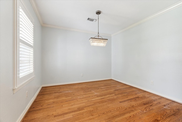 1710 Gardenia Dr, Houston, TX 77018 - empty room with crown molding, light wood-style flooring, and a chandelier