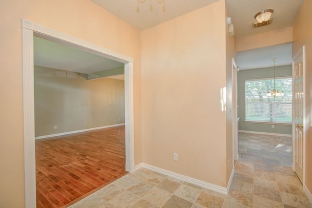 2917 Veva Dr, Pearland, TX 77584 - corridor featuring a chandelier and baseboards