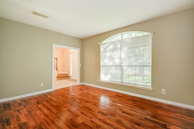 2917 Veva Dr, Pearland, TX 77584 - unfurnished room with wood finished floors, healthy amount of natural light, and stairway