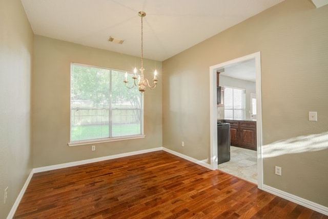2917 Veva Dr, Pearland, TX 77584 - spare room with wood finished floors and a chandelier