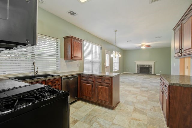 2917 Veva Dr, Pearland, TX 77584 - kitchen with black range with gas cooktop, dishwasher, ceiling fan, a peninsula, and a fireplace
