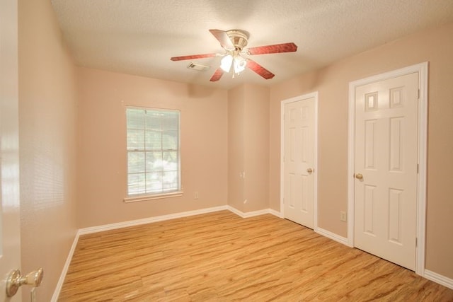 2917 Veva Dr, Pearland, TX 77584 - spare room featuring light wood finished floors, ceiling fan, and a textured ceiling