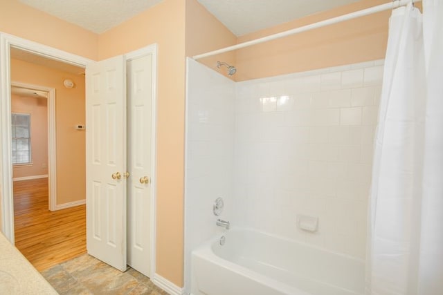 2917 Veva Dr, Pearland, TX 77584 - bathroom featuring shower / tub combo with curtain and baseboards