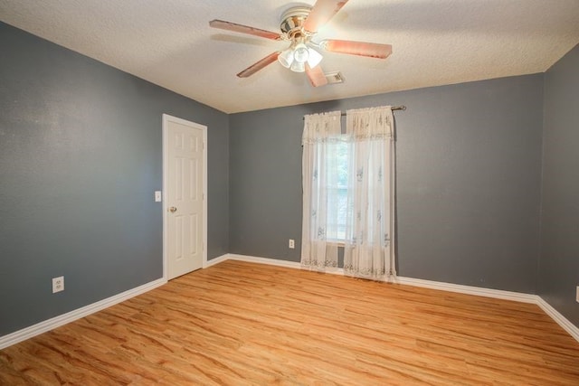 2917 Veva Dr, Pearland, TX 77584 - unfurnished room featuring light wood finished floors, ceiling fan, and a textured ceiling
