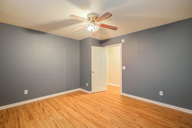 2917 Veva Dr, Pearland, TX 77584 - spare room featuring light wood finished floors, a ceiling fan, and a textured ceiling
