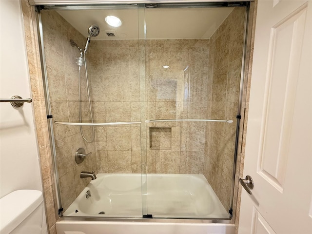 3525 Sage Rd Unit 1204, Houston, TX 77056 - bathroom featuring toilet and shower / bath combination with glass door