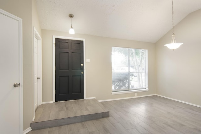 16822 Applecross Ln, Houston, TX 77084 - entrance foyer featuring wood finished floors, vaulted ceiling, and a textured ceiling