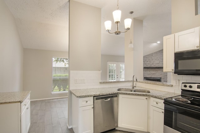 16822 Applecross Ln, Houston, TX 77084 - kitchen with stainless steel appliances, lofted ceiling, tasteful backsplash, a chandelier, and light stone counters