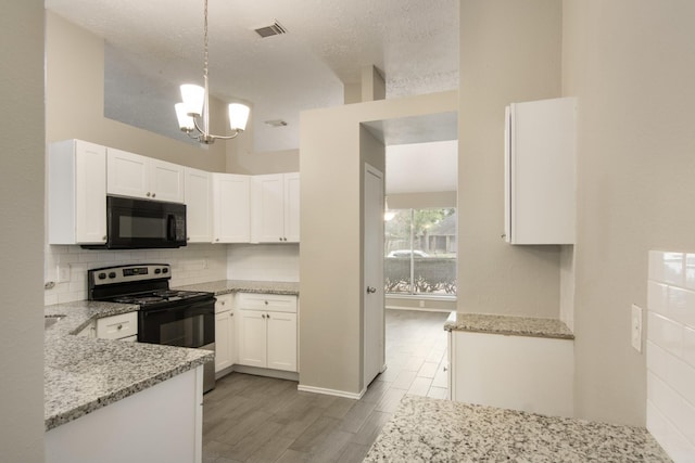 16822 Applecross Ln, Houston, TX 77084 - kitchen featuring black appliances, light wood finished floors, light stone counters, tasteful backsplash, and a chandelier