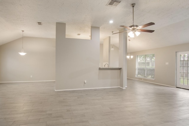 16822 Applecross Ln, Houston, TX 77084 - unfurnished living room with lofted ceiling, a textured ceiling, wood finished floors, a ceiling fan, and a chandelier