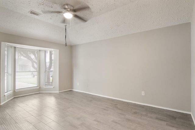 16822 Applecross Ln, Houston, TX 77084 - unfurnished room with a textured ceiling, a ceiling fan, and wood finished floors