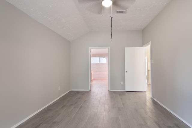 16822 Applecross Ln, Houston, TX 77084 - spare room featuring a textured ceiling, wood finished floors, ceiling fan, and vaulted ceiling