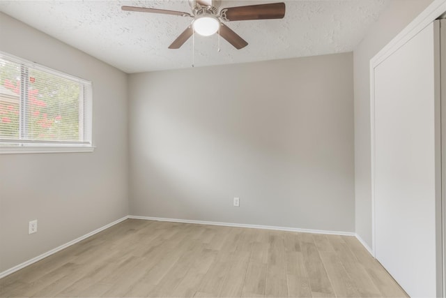 16822 Applecross Ln, Houston, TX 77084 - unfurnished room with light wood finished floors, a textured ceiling, and a ceiling fan