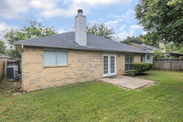 16822 Applecross Ln, Houston, TX 77084 - back of property featuring french doors, a fenced backyard, a chimney, a shingled roof, and a patio