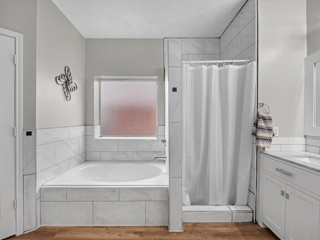 13923 Roanoke Falls Dr, Cypress, TX 77429 - bathroom with a stall shower, vanity, a garden tub, and wood finished floors