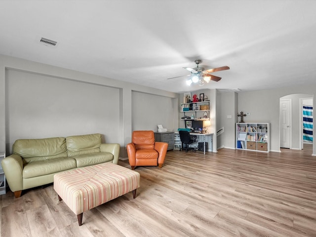 13923 Roanoke Falls Dr, Cypress, TX 77429 - living area featuring a desk, wood finished floors, arched walkways, and ceiling fan