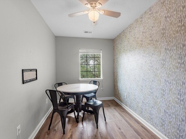 13923 Roanoke Falls Dr, Cypress, TX 77429 - dining space featuring wallpapered walls, light wood finished floors, and ceiling fan