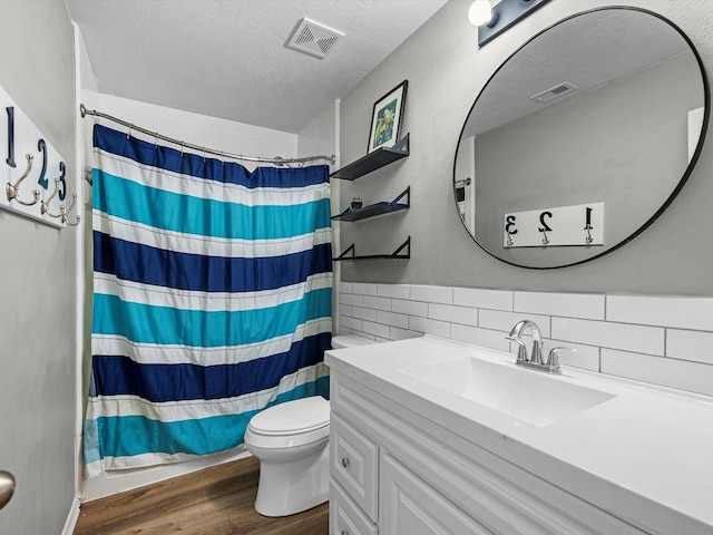 13923 Roanoke Falls Dr, Cypress, TX 77429 - bathroom featuring wood finished floors, vanity, backsplash, a shower with curtain, and a textured ceiling