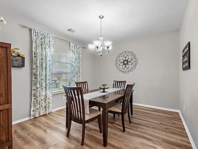 13923 Roanoke Falls Dr, Cypress, TX 77429 - dining area featuring light wood-type flooring and a chandelier