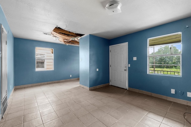 14504 Corpus Christi St Unit 4, Houston, TX 77015 - tiled spare room with baseboards and a textured ceiling