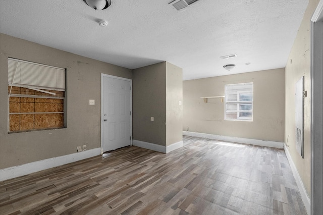 14504 Corpus Christi St Unit 4, Houston, TX 77015 - empty room featuring wood finished floors, a textured ceiling, and a smoke detector