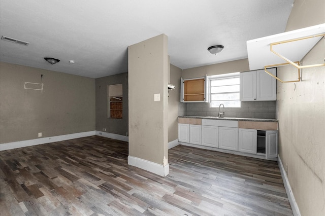 14504 Corpus Christi St Unit 4, Houston, TX 77015 - kitchen featuring wood finished floors, backsplash, white cabinetry, and open floor plan