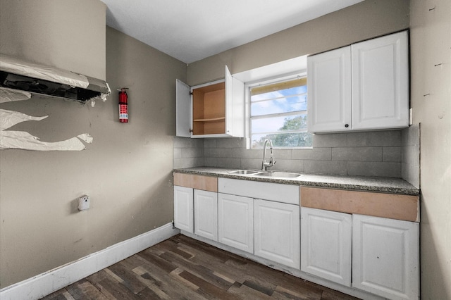 14504 Corpus Christi St Unit 4, Houston, TX 77015 - kitchen featuring dark wood-type flooring, tasteful backsplash, and white cabinetry