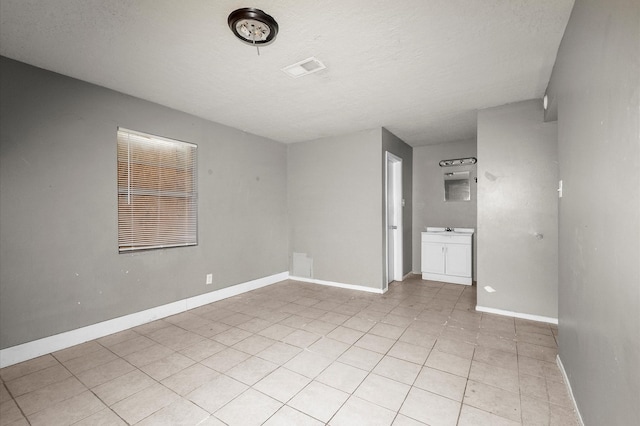 14504 Corpus Christi St Unit 4, Houston, TX 77015 - spare room with light tile patterned flooring and a textured ceiling