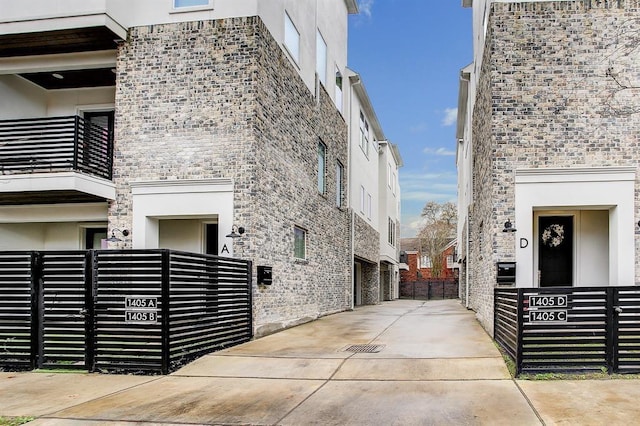 1405 Indiana St Unit B, Houston, TX 77006 - view of home's exterior featuring stucco siding and stone siding