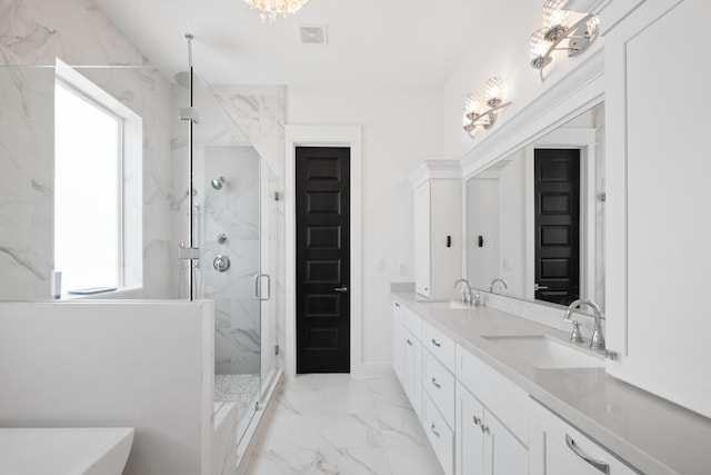 1405 Indiana St Unit B, Houston, TX 77006 - bathroom with marble finish flooring, a chandelier, a marble finish shower, double vanity, and a freestanding tub