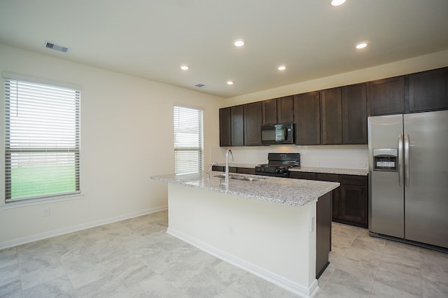 4615 Sabine Creek Way, Katy, TX 77449 - kitchen featuring black appliances, healthy amount of natural light, a center island with sink, dark brown cabinets, and recessed lighting