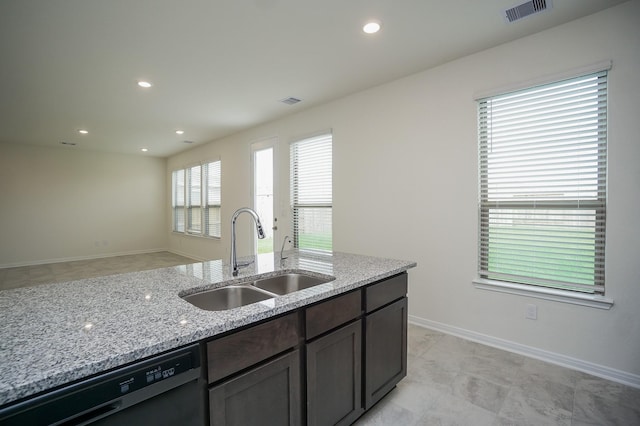 4615 Sabine Creek Way, Katy, TX 77449 - kitchen with black dishwasher, light stone counters, recessed lighting, open floor plan, and dark brown cabinetry