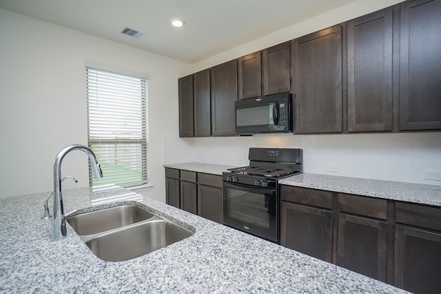 4615 Sabine Creek Way, Katy, TX 77449 - kitchen featuring black appliances, dark brown cabinetry, tasteful backsplash, light stone counters, and recessed lighting