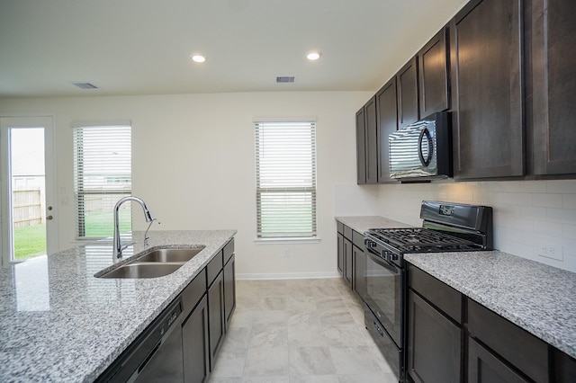 4615 Sabine Creek Way, Katy, TX 77449 - kitchen with black appliances, backsplash, healthy amount of natural light, dark brown cabinets, and recessed lighting
