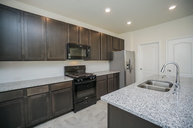 4615 Sabine Creek Way, Katy, TX 77449 - kitchen featuring black appliances, tasteful backsplash, recessed lighting, light stone counters, and dark brown cabinetry