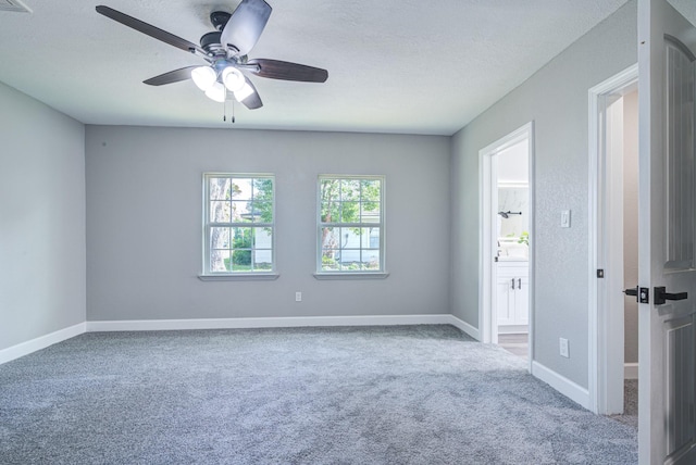 1111 Robinson St, Alvin, TX 77511 - unfurnished room featuring carpet, ceiling fan, and a textured ceiling